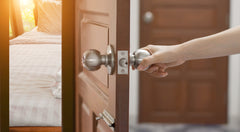 woman holding door knob handle