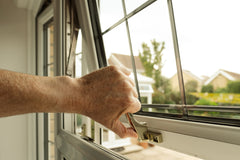 Homeowner seen about to lock a double glazed window